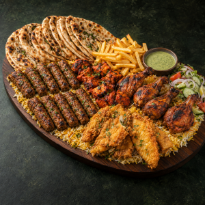 BBQ Platter 4 with kebabs, chicken tikka, Lahori fish, chicken legs, naan and sides